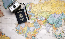 Image of a map with an old camera and passport placed on it